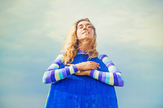 Peaceful woman with surfboard