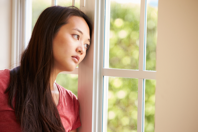 Woman Looking Out Window