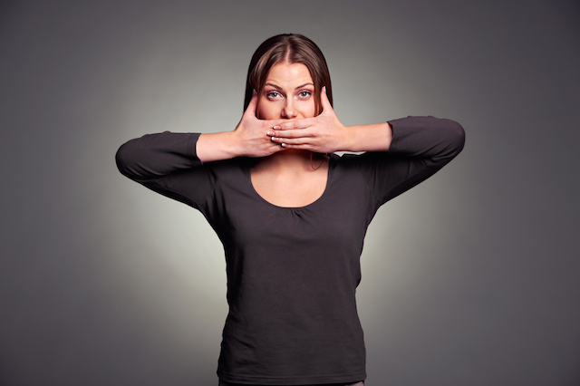 Woman with hand over her mouth