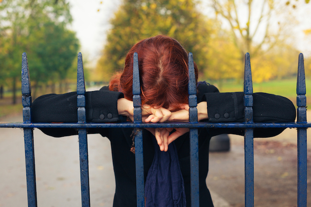 Sad Woman Behind Bars