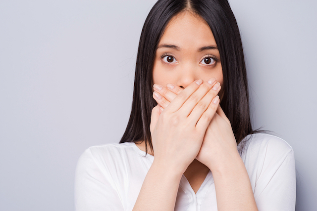 Woman Covering Mouth