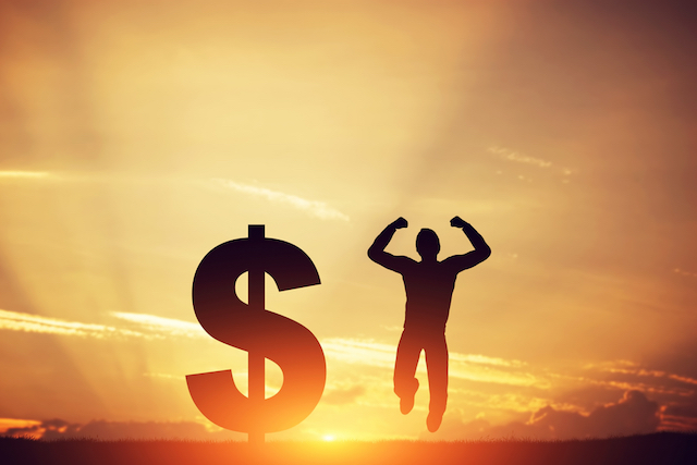 Man Jumping Next to Dollar Symbol