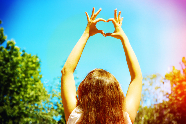 Woman with heart hands